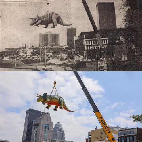 A dinosaur model being lifted by a crane over a city skyline, blending historical and modern imagery.