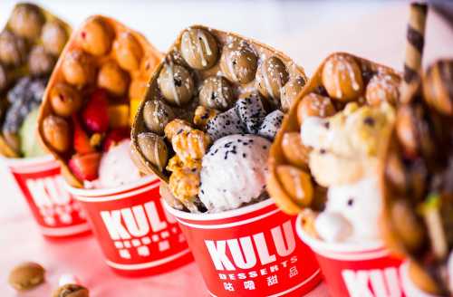 Four colorful dessert cups filled with ice cream, toppings, and unique treats from KULU Desserts.