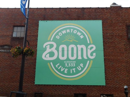 Mural on a brick wall reading "Downtown Boone, Elevation 3,333, Live It Up" with a green background.