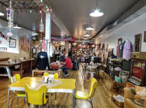 A cozy vintage shop with wooden floors, colorful decor, and various antiques displayed throughout the space.