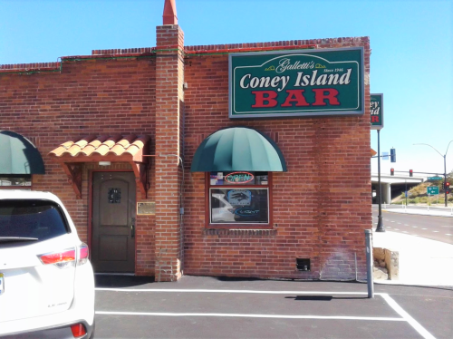 Exterior of Gallett's Coney Island Bar, featuring a brick facade, green awning, and a sign above the entrance.