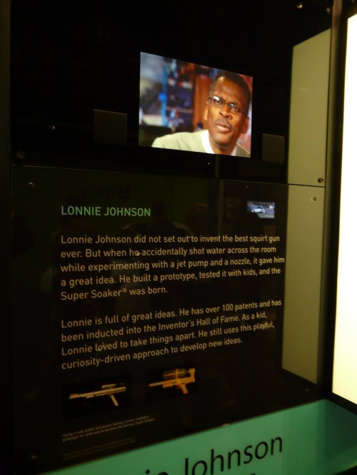 Image of a display featuring Lonnie Johnson, inventor of the Super Soaker, with a photo and text about his achievements.