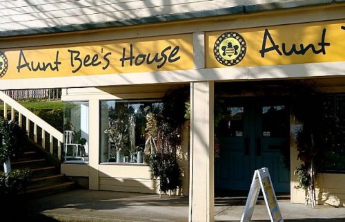 Exterior of Aunt Bee's House, featuring a yellow sign with the name and a welcoming entrance.