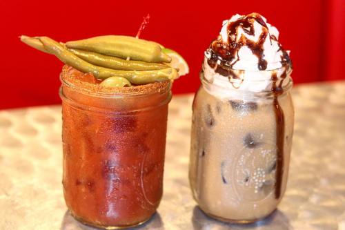 Two drinks in mason jars: a spicy Bloody Mary with green beans and a dessert drink topped with whipped cream and chocolate.