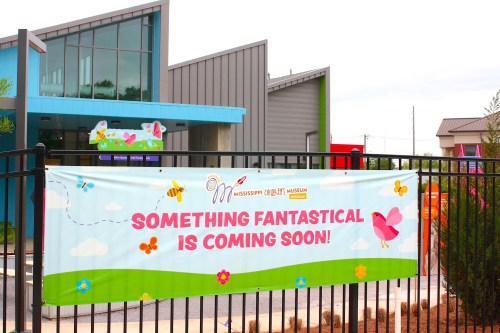 A colorful banner outside the Mississippi Children's Museum announces "Something fantastical is coming soon!"
