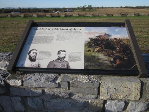 Historical marker detailing a Civil War battle, featuring images of soldiers and a battlefield scene.