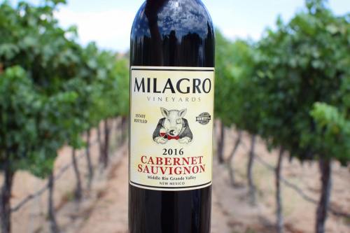 A bottle of Milagro Vineyards 2016 Cabernet Sauvignon in a vineyard setting.