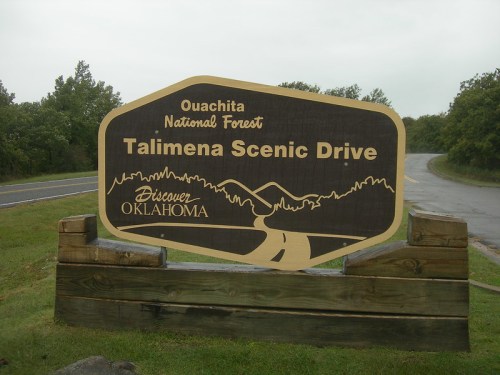 Sign for Talimena Scenic Drive in Ouachita National Forest, featuring mountains and the text "Discover Oklahoma."