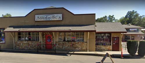 Exterior of Annabelle's Chocolate Lounge, featuring a stone facade, red door, and an "Open" sign.