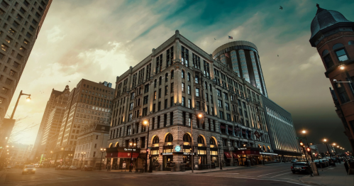 Historic building at sunset, showcasing a mix of architectural styles with a dramatic sky in the background.
