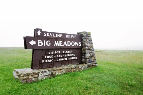 Signpost for Big Meadows on Skyline Drive, indicating visitor center, food, gas, lodging, picnic, and ranger station.