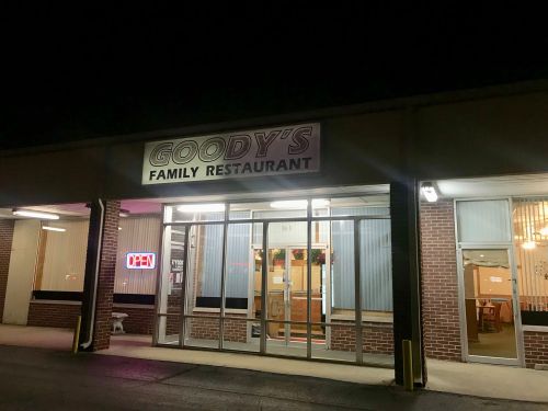 Exterior of Goody's Family Restaurant at night, featuring an "Open" sign and welcoming entrance.