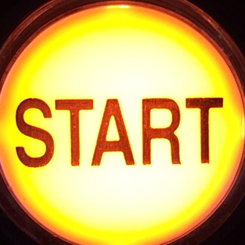 A glowing orange button with the word "START" prominently displayed in bold letters.