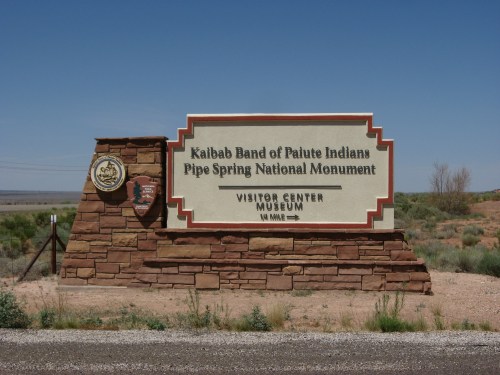Sign for the Kaibab Band of Paiute Indians at Pipe Spring National Monument, featuring a visitor center and museum.