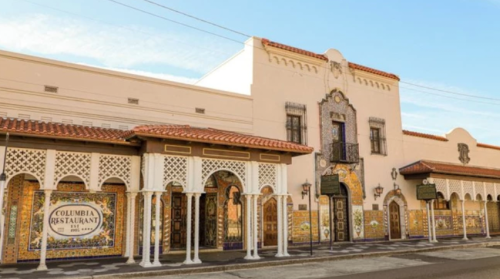 Exterior of the Columbia Restaurant, featuring colorful tiles and ornate architectural details under a clear blue sky.