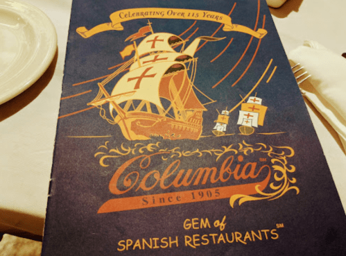A menu cover featuring a ship design, celebrating Columbia's 115 years as a gem of Spanish restaurants since 1905.
