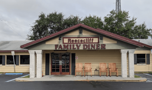 Exterior of Reesecliff Family Diner, featuring a welcoming entrance and rocking chairs on the porch.