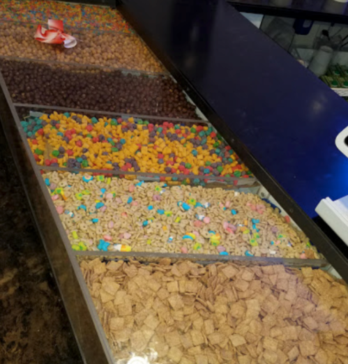 A colorful assortment of candies and snacks displayed in bins at a candy shop.