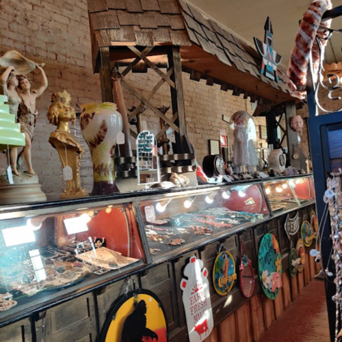 A colorful display of various decorative items and souvenirs in a rustic shop setting.