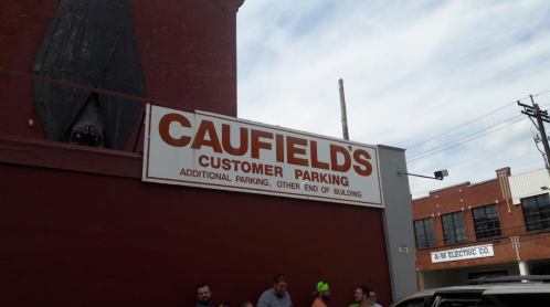 Sign for Caufield's Customer Parking, indicating additional parking at the other end of the building.