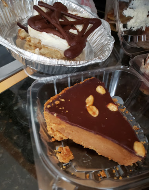 Two dessert slices: one with chocolate topping and nuts, the other with a creamy layer and chocolate drizzle.