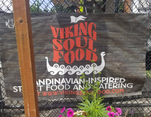 Sign for "Viking Soul Food," featuring a Viking ship and text about Scandinavian-inspired street food and catering.