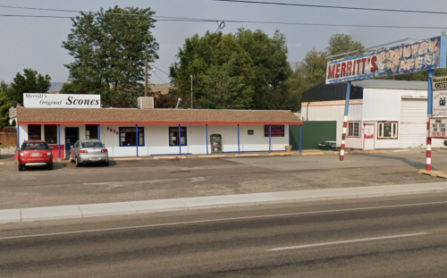 A small diner with a sign reading "Merritt's Country Cafe" and parked cars in front, set along a quiet street.