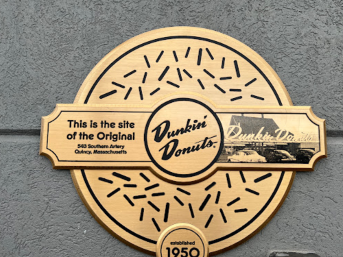 Plaque marking the site of the original Dunkin' Donuts in Quincy, Massachusetts, established in 1950.