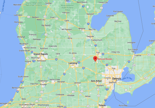 Map of Michigan highlighting the location of Beloved Books near Lansing, with nearby cities like Grand Rapids and Detroit.