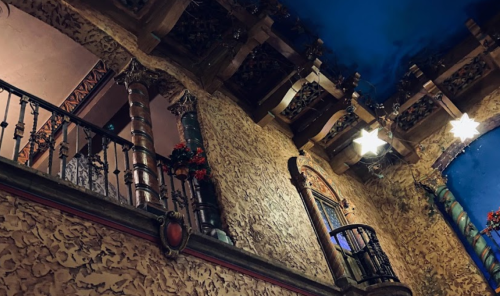 Interior view of a decorative space featuring ornate walls, balconies, and a starry ceiling.
