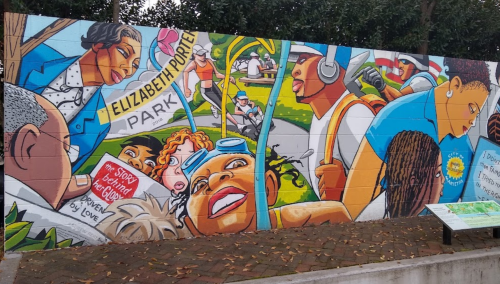 Colorful mural depicting diverse people engaged in community activities, celebrating history and unity in Elizabeth Porter Park.