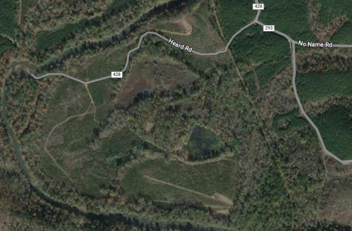 Aerial view of a forested area with winding roads and a river, featuring Heard Rd and No Name Rd.