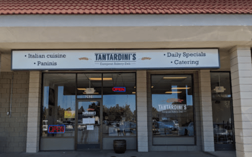 Exterior of Tantardini's European Bakery-Deli, featuring a sign with "Open" and offerings like Italian cuisine and catering.