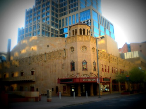 Historic Orpheum Theatre with ornate architecture, surrounded by modern buildings in an urban setting.