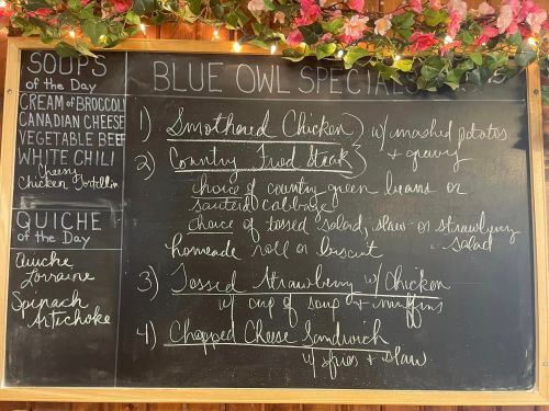 Chalkboard menu featuring daily specials: Smothered Chicken, Country Fried Steak, Tossed Strawberry Chicken, and Chopped Cheese Sandwich.