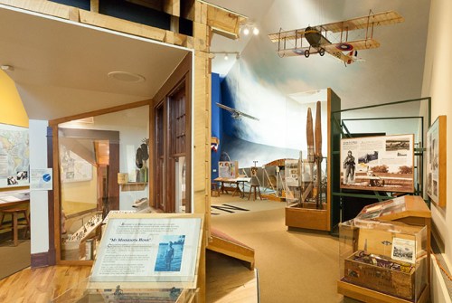 A museum exhibit featuring vintage aircraft, informational displays, and historical artifacts related to aviation.