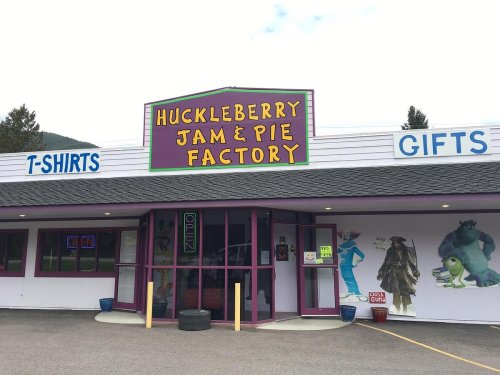 Exterior of the Huckleberry Jam & Pie Factory, featuring colorful signage and cartoon characters on the wall.
