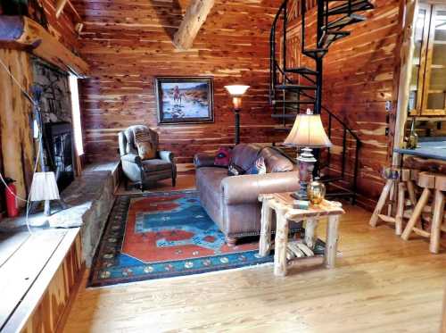 Cozy wooden cabin interior featuring a spiral staircase, comfortable seating, and warm lighting.