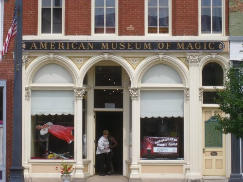 Exterior of the American Museum of Magic, featuring arched windows and a sign above the entrance.