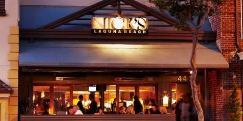 Exterior view of Nick's restaurant in Laguna Beach, featuring a warm ambiance and outdoor seating.