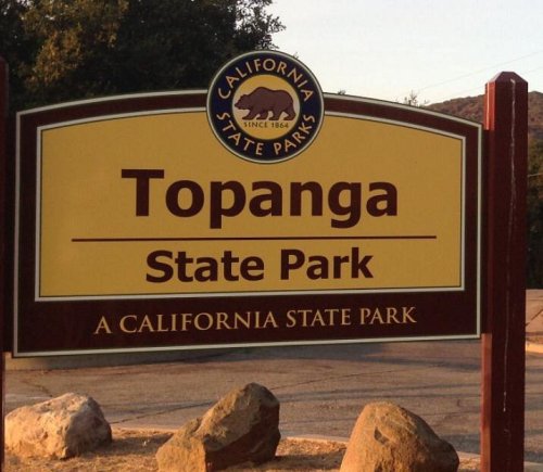 Sign for Topanga State Park in California, featuring a bear logo and stating it's a California State Park.
