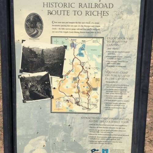 Sign detailing the historic railroad route, featuring a map and information about Phantom Canyon and camping opportunities.