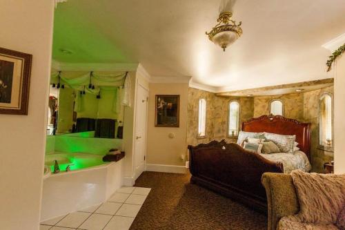Cozy bedroom with a large bed, a spa tub, and soft lighting, featuring elegant decor and a warm atmosphere.