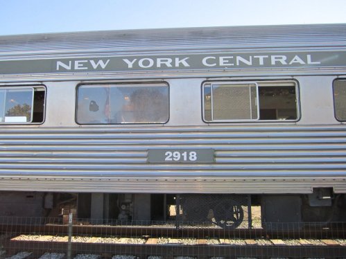 Side view of a vintage train car with "New York Central" and the number "2918" displayed on the exterior.