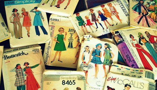 A collection of vintage sewing patterns from brands like Butterick and Simplicity, featuring various dress designs.