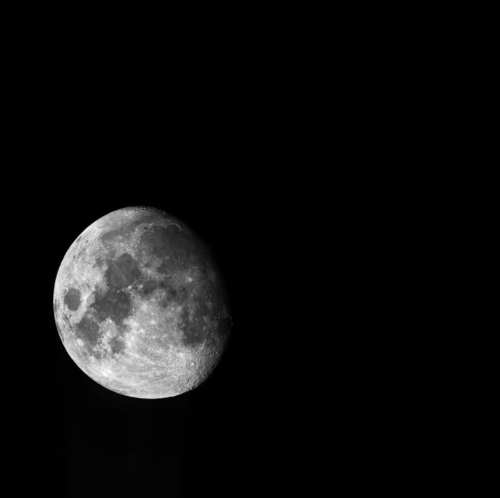 A close-up view of a full moon against a dark night sky, showcasing its craters and surface details.