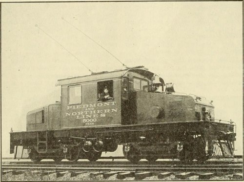 A vintage electric locomotive labeled "Piedmont and Northern Lines 5000" on railway tracks.