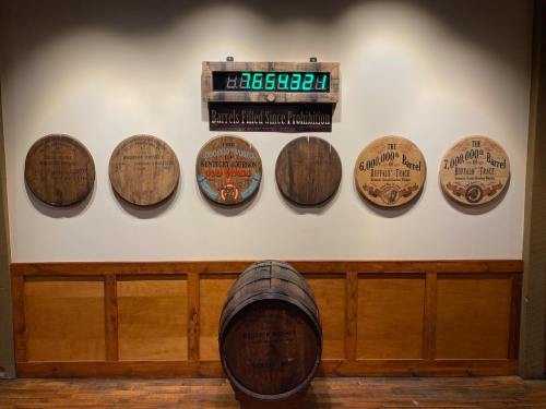 A display of wooden barrel heads on a wall, with a digital counter showing barrels filled since Prohibition.