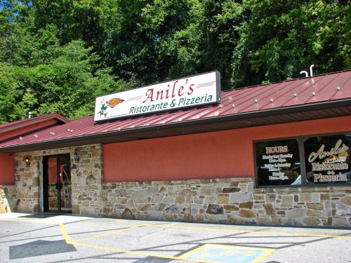 Exterior of Anile's Ristorante & Pizzeria, featuring a stone facade and a sign with the restaurant's name.
