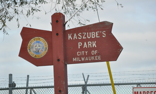 Signpost for Kaszube's Park in Milwaukee, featuring the city seal and directional arrow.